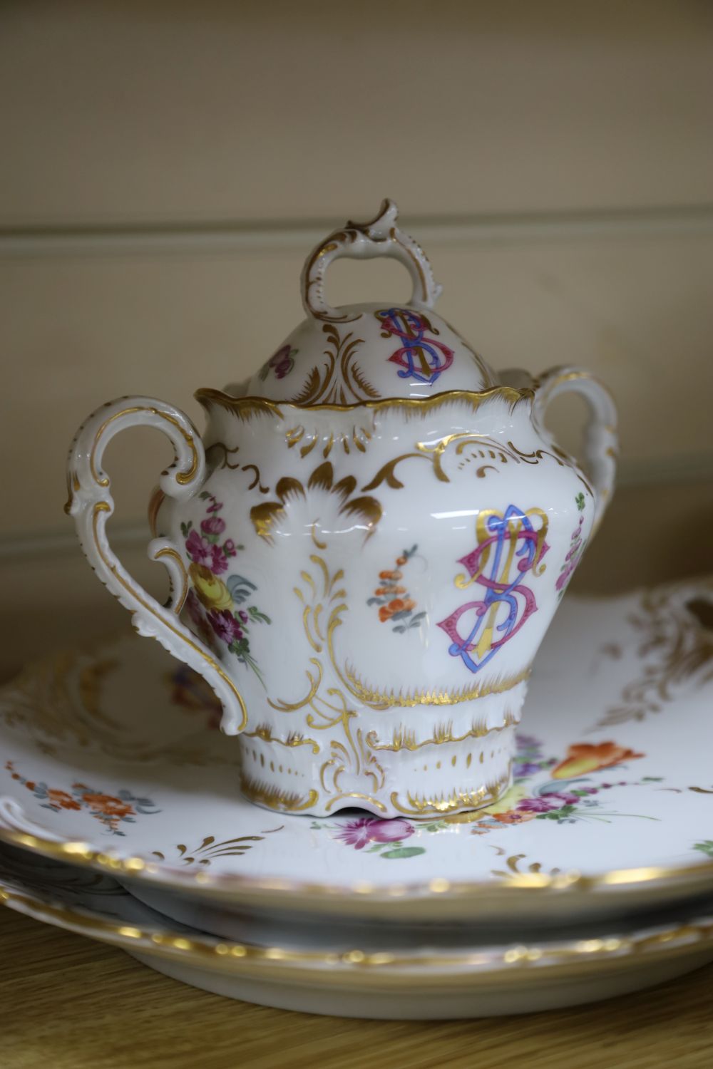 A 19th century Continental twenty nine piece gilt and floral coffee set, monogrammed, coffee pot 26cm